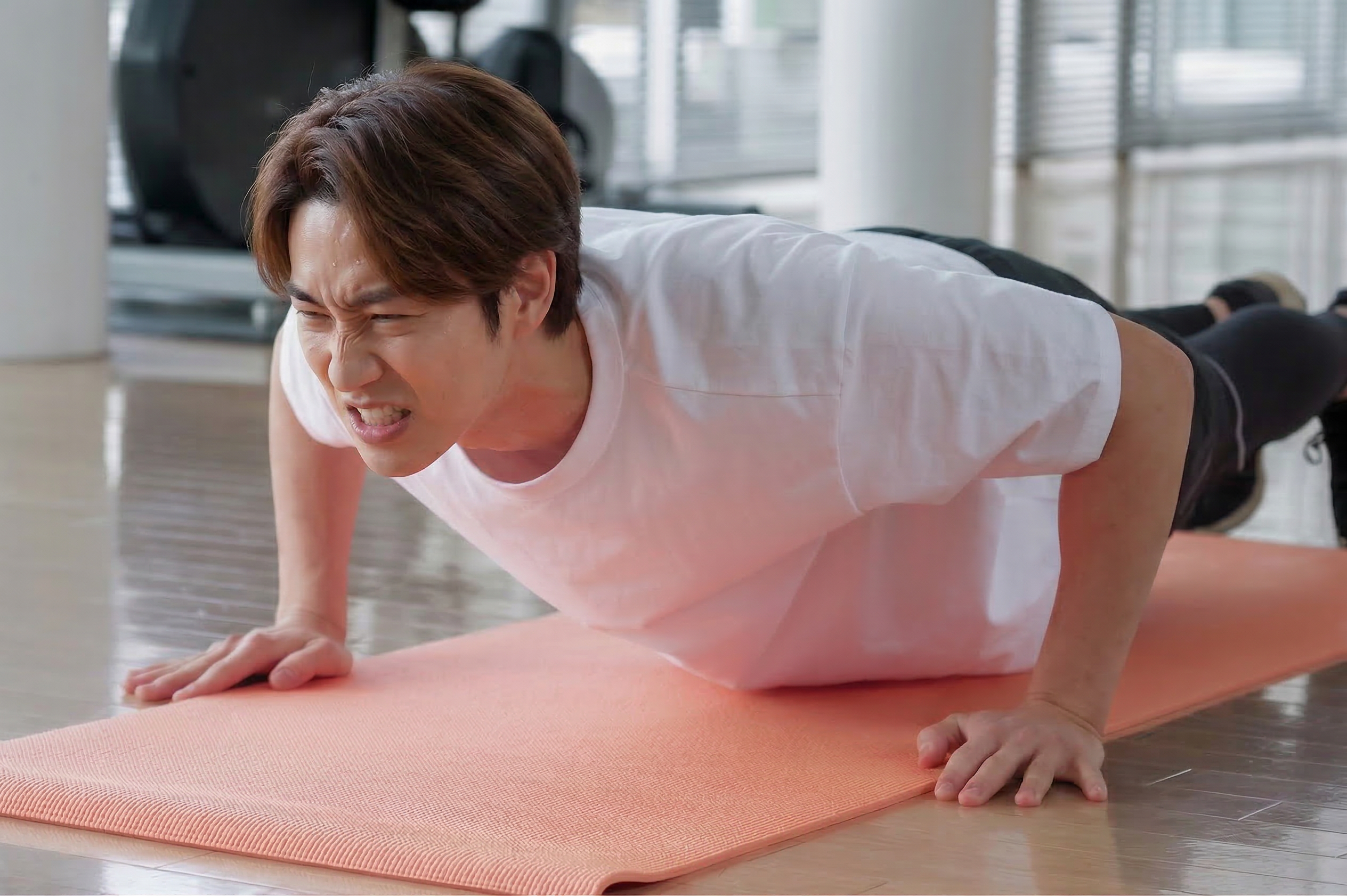 ジムで腕立て伏せをする男性